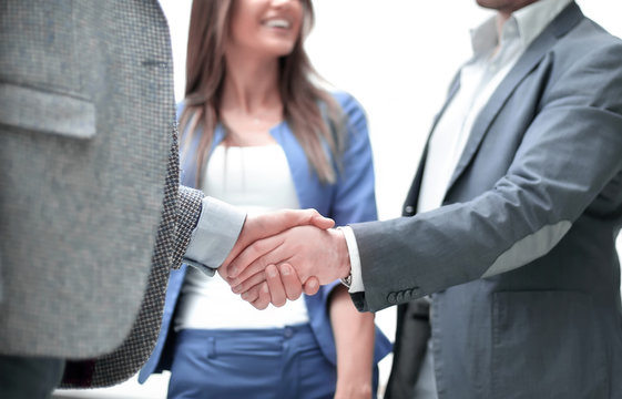business people greet each other with a handshake