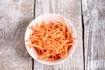 a bowl of grated carrots