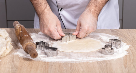 male cook preparing Christmas cookies