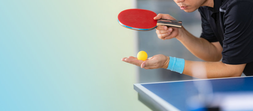 Ping pong table, Male playing table tennis with racket and ball in a sport hall
