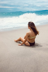 Girl sitting by the shore