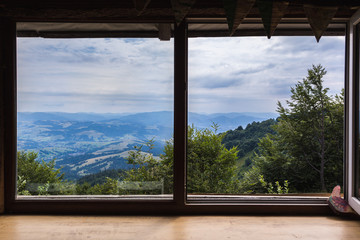 Mountains, view from the window of a wooden house