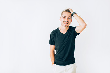 Happy young man laughing, holding one hand over his head on white isolated background.