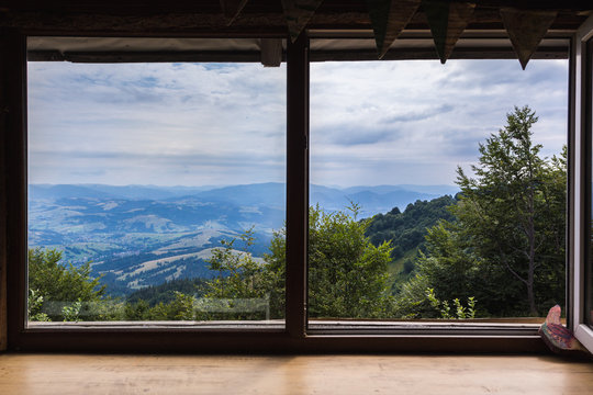 Fototapeta Mountains, view from the window of a wooden house