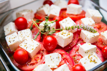 a bowl of fresh summer tomato and cheese salad