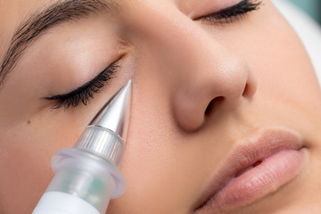 Woman having non surgical rejuvenation cosmetic facial.