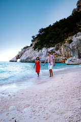 couple men and woman on summer vacation Sardinia, couple on the ebach of Cala Goloritze Sardegna Italy