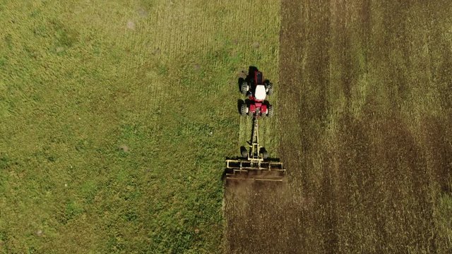 Aerial Drone Shot of Albertan Tractor Discing Field At The End of the Summer Calgary Alberta Canada Agriculture