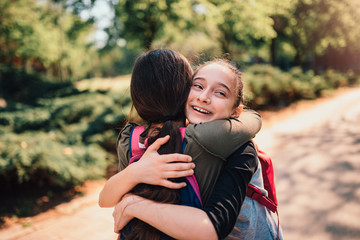 Schoolgirls hugging on first day of school