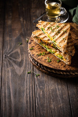 Food background with healthy toasts with avocado, cheddar cheese and tomatoes for breakfast or lunch. Vegetarian sandwiches. Plant-based diet concept.