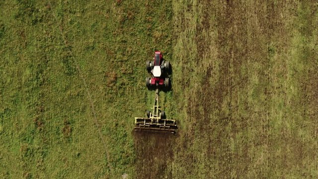 Aerial Drone Shot of Albertan Tractor Discing Field At The End of the Summer Calgary Alberta Canada Agriculture