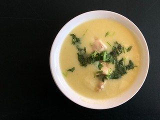 A man who cannot swim stands wearing several inflatable rings and looks at the sea.
