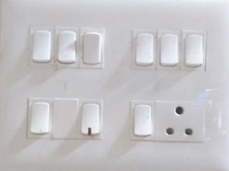 white switches for different facilities on the wall