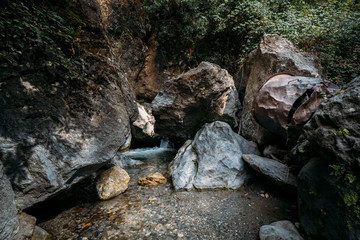 River, calm water where the waterfall breaks the peace of the place. Rocks, trees and water merge...
