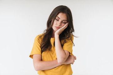 Image of tired brunette woman wearing casual clothes propping up her head with hand