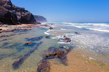 Aerial from the beach and ocean at Praia Vale Figueiras in Portugal