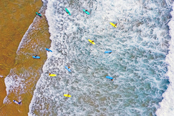 Aerial from surfers getting surfing lessons at the atlantic ocean