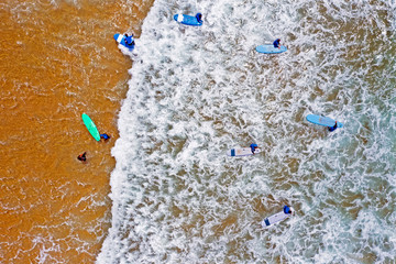Top shot from surfers getting surfers lessons in the atlantic ocean