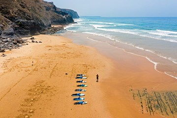 Aerial from surfers getting surfers lessons at Praia Vale Figueiras in Portugal