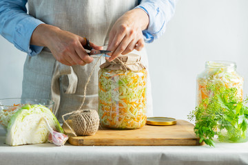 The preparation process fermentation preservation Sauerkraut on a light background. Natural rustic style. Canned food