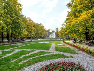 Flowerbeds with a fountain in the Saxon Garden in Warsaw (Poland) on an autumn sunny day. Beautiful scenery of the oldest public park in the center of the Polish capital