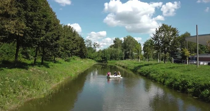 Two people on a boat floating on the river.