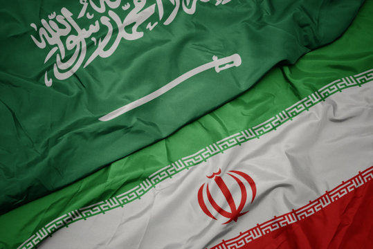 waving colorful flag of iran and national flag of saudi arabia.