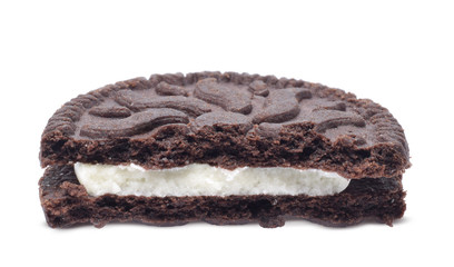Chocolate cookie halved with cream filling closed up isolated on white
