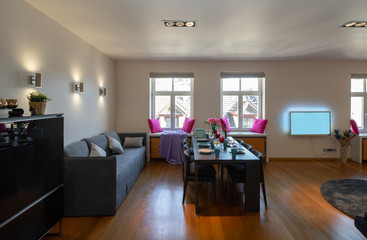 Modern interior of living room with furniture and tv.