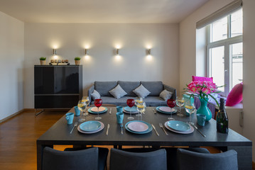 Modern interior of spacious room. Served table.