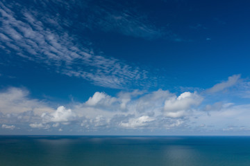 Fototapeta na wymiar Peaceful sea and cloudy blue sky. Horizon line.