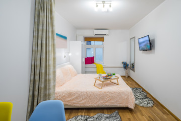 King-size bed in the spacious bedroom. TV on the wall.