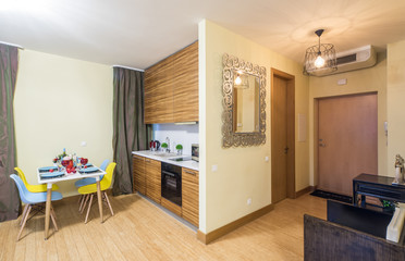 Modern interior of studio apartment. Ktchen set. Entrance hall. Mirror.