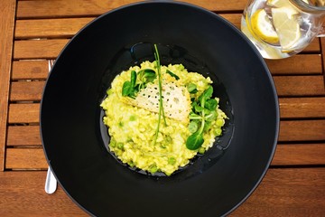 Vegetarian risottto with peas, lettuce and cheese.
