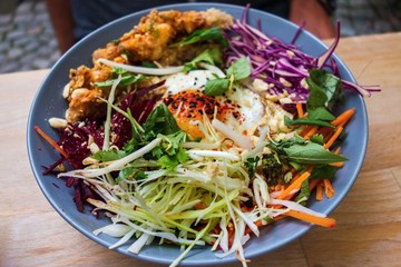 Asian meal with grated vegetable, egg and chicken in breadcrumb.