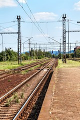 Fototapeta premium Close up of empty straight railroad track in Czech Republic. Perspective view. Railroad tracks with concrete sleepers.