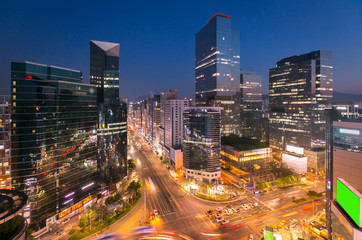 Seoul city Skyling and Skyscraper and Traffic at niaht intersection in Gangnam, South Korea.