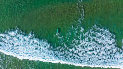 Surfer on Freshwater West Beach in Pembrokeshire, Wales, UK