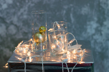 Christmas decor, festoon, glass cups and Christmas balls. Bright Christmas background