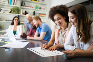 Cheerful coworkers in office during company meeting