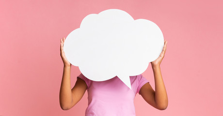 Empty speech bubble at girl's hands on pink background
