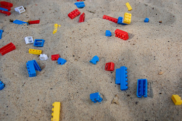 Fototapeta na wymiar blocks multicolored toys in the sandbox