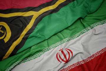 waving colorful flag of iran and national flag of Vanuatu .