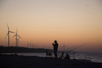 Wind turbines by the sea at sunrise