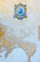 Colorful ceramic mosaic on a grungy weathered wall in Albufeira, Portugal