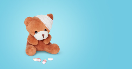 Teddy bear doll with pills background