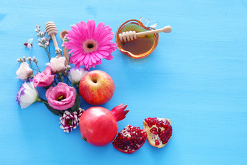 religion image of Rosh hashanah (jewish New Year holiday) concept. Traditional symbols over wooden blue background
