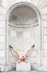 Beautiful gymnastic woman stretching outdoors