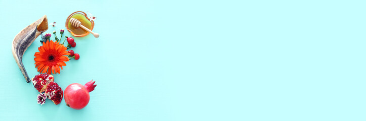 religion image of Rosh hashanah (jewish New Year holiday) concept. Traditional symbols over wooden mint blue pastel background