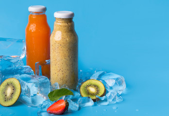 Summer drinks of fresh blended fruits in glass bottles